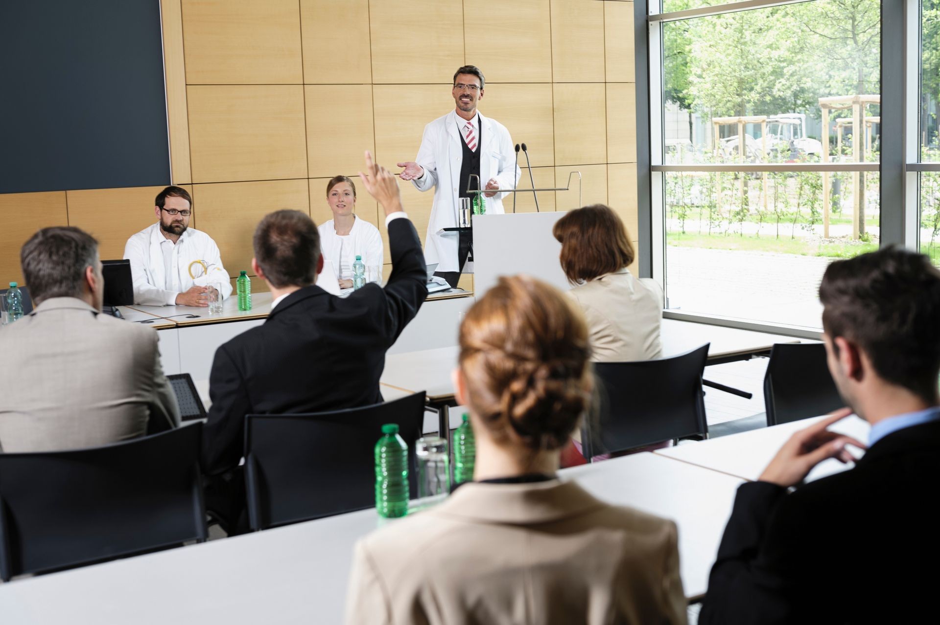 Doctors giving talk in conference room